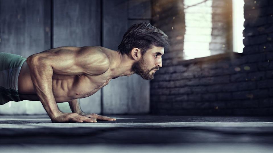  A photo of a man doing a push up . 