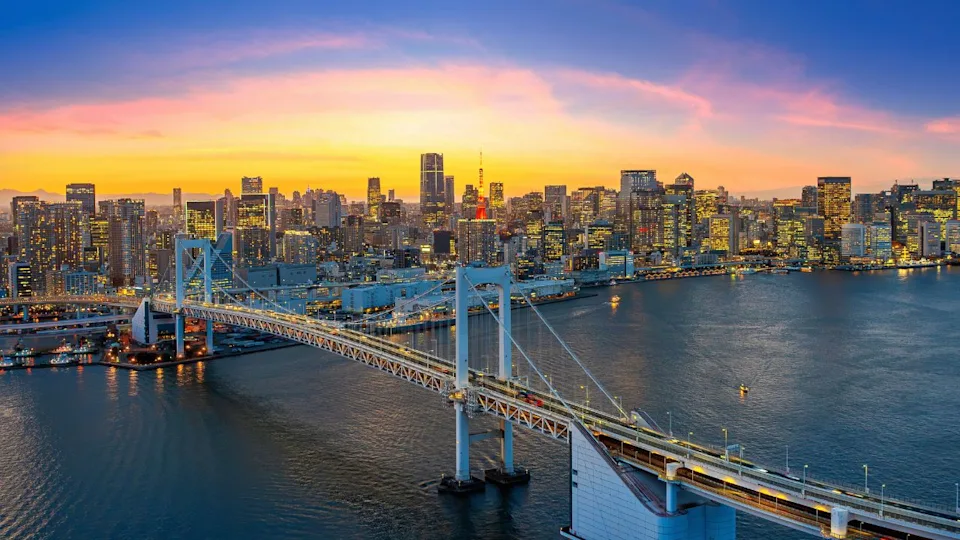 Rainbow bridge and Tokyo cityscape at sunset, Japan.