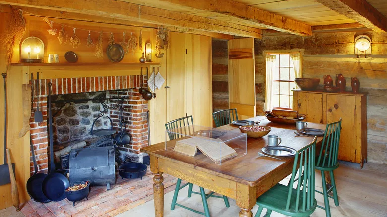 Interior of a historic log cabin with a fireplace