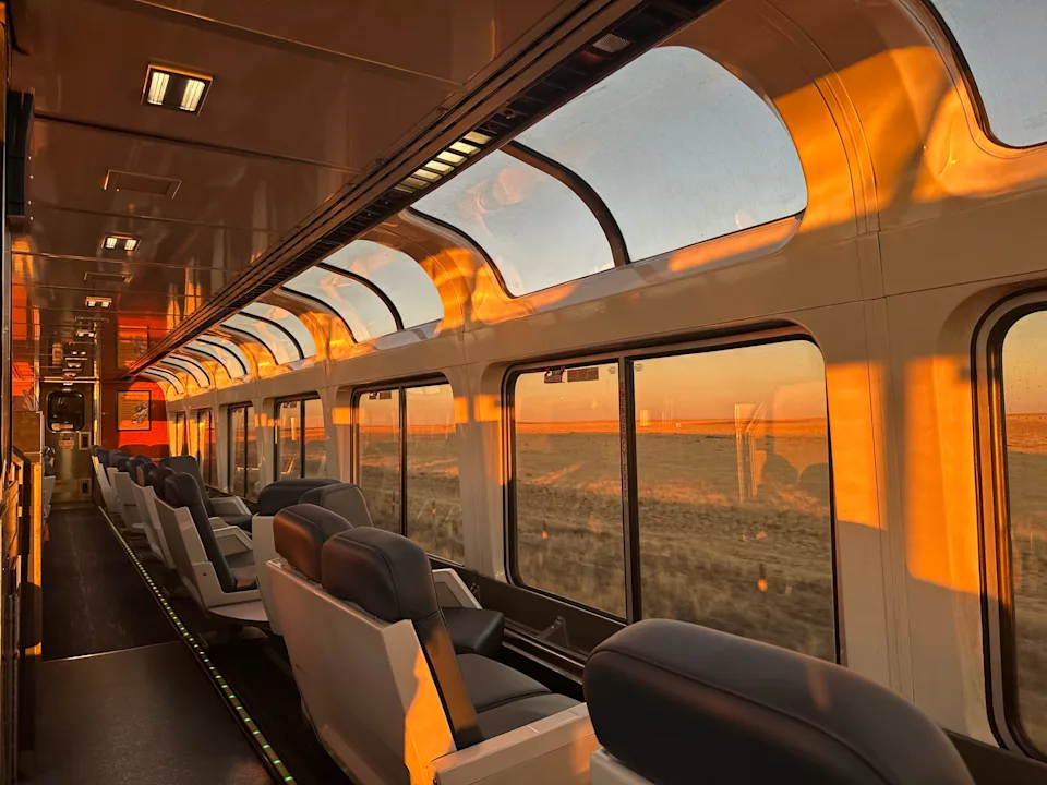 Observation car in a golden glow from the sunset.