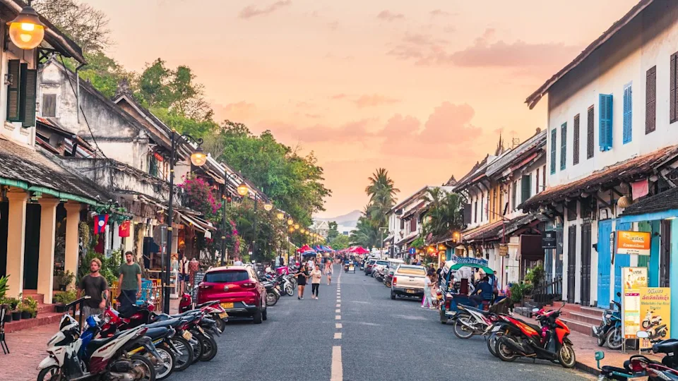 Luang Prabang, Laos - May 30th, 2023: A Scenic Stroll: Luang Prabang's Old Quarter with Stunning Views of Phousi Mountain and Charming Shopping Houses