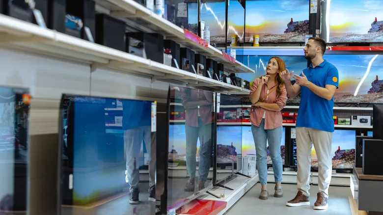 Couple buying a TV in an electronics store