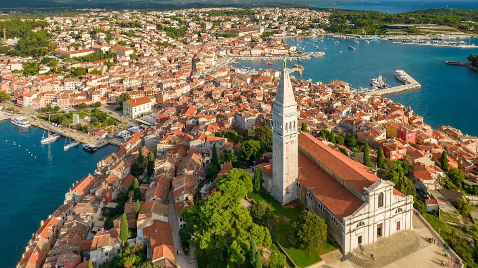 Aerial view of the Rovinj old town, famous ancient Croatian city at the Adriatic sea, Istria peninsula, Croatia. Rovinj cityscape, cathedral of St. Euphemia and historic buildings at sunset
