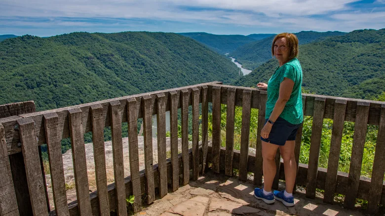 A woman stands on an overlook in New River Gorge, West Virginia
