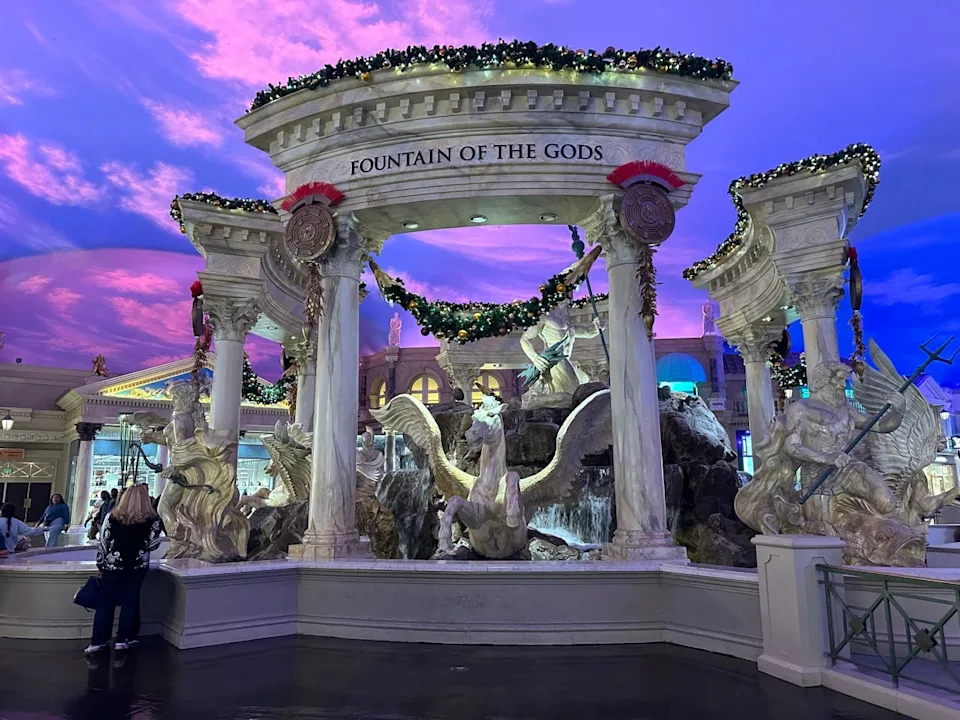 The Forum pillars and statues decorated with lights and wreaths for Christmas