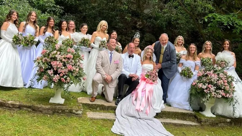 Queen candidates in white dresses with pink flowers in Laurel Cove during the Kentucky Mountain Laurel Festival