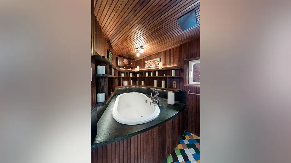 The home also features a wood-lined tub with built-in shelving.