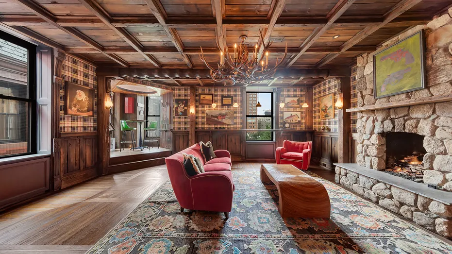 The great room features a stone-framed fireplace.