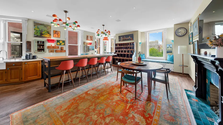 The kitchen features a large eat-in island, and is connected to the dining room. The room also contains a fireplace.