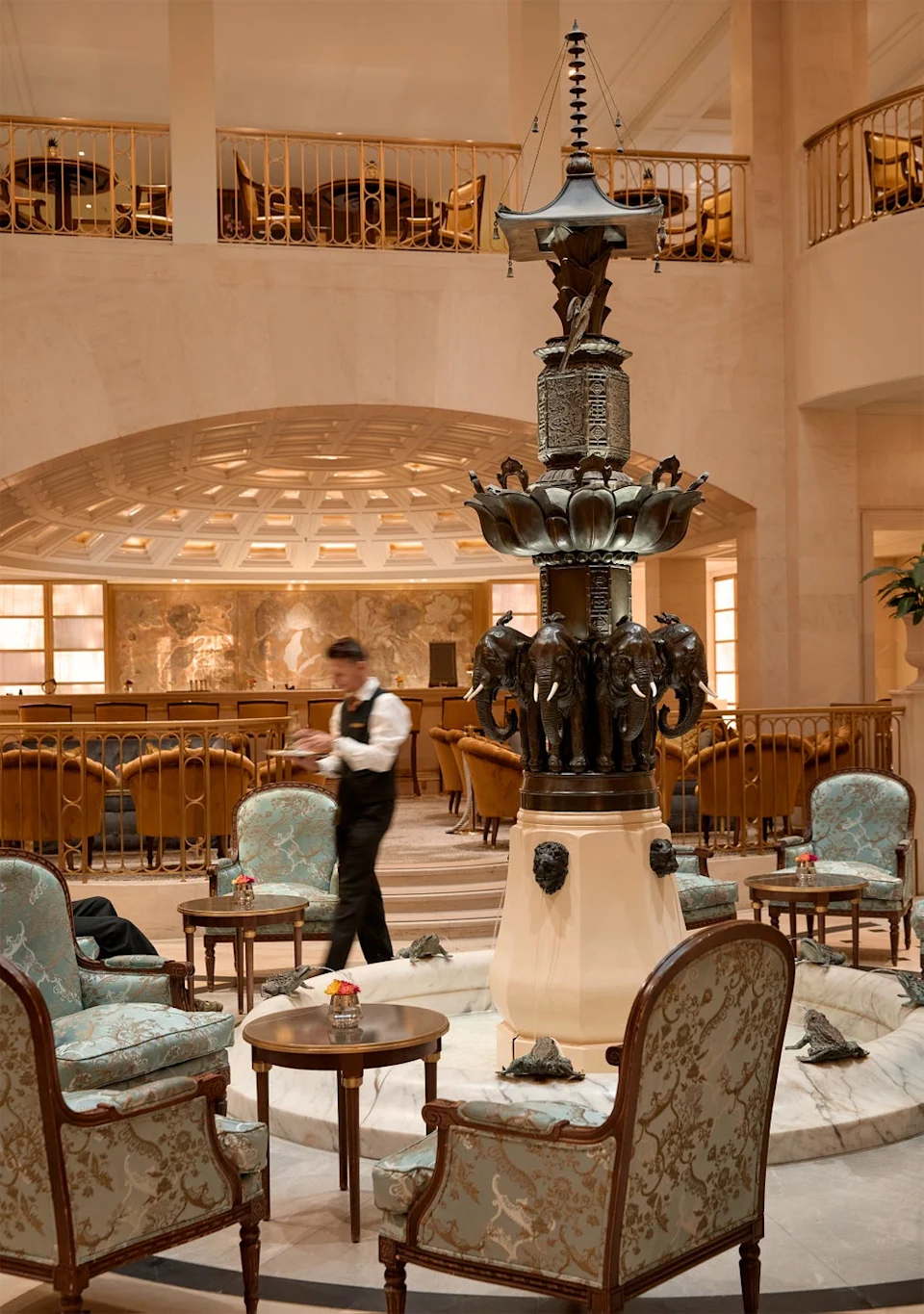 Lobbly lounge of Hotel Adlon Kempinski in Berlin Luxurious lounge area featuring a decorative fountain and elegant seating.