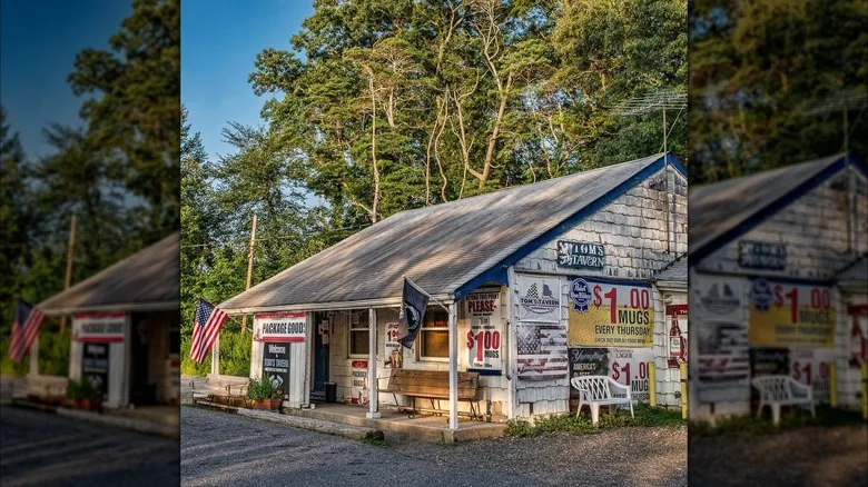 Exterior shot of Tom's Tavern, small white house in gravel parking lot