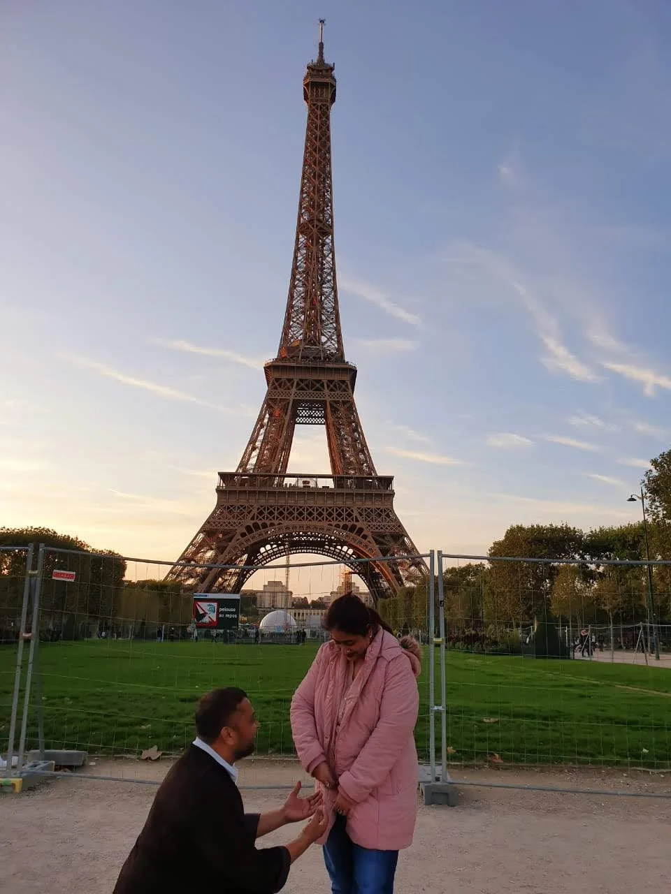 The author's parents pose for a silly picture in front of the Eiffel Tower.