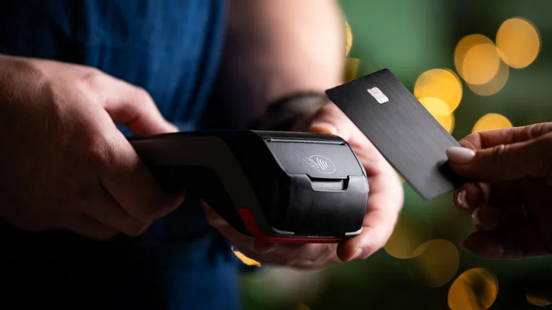 Person swiping credit card into reader