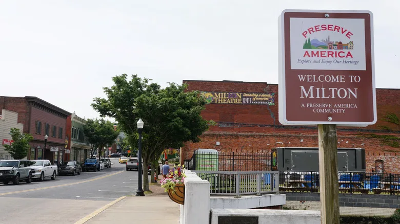 Milton street scene with businesses and welcome sign