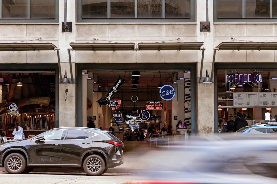Adrian Rudd/Travel + Leisure Cars driving past Grand Central Market in downtown L.A.