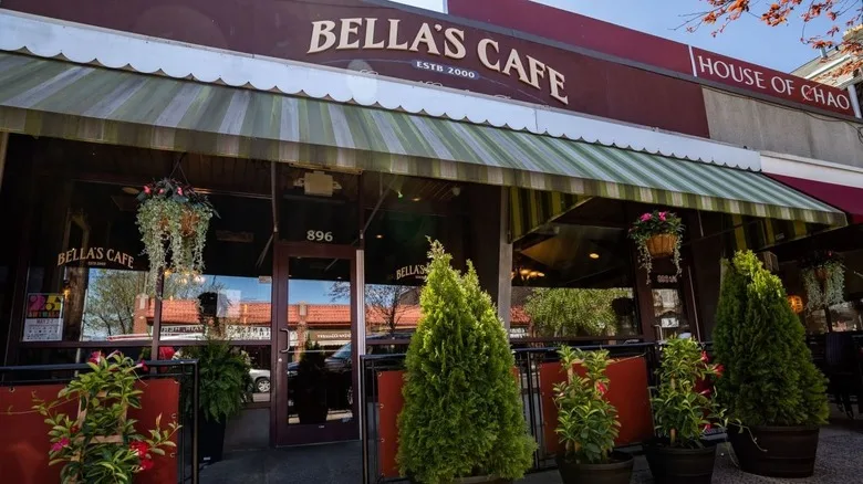 The exterior of Bella's Cafe with a green and white awning