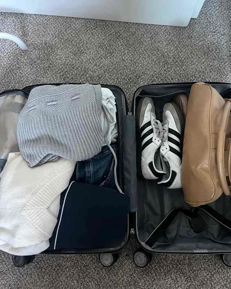 Clothes in carry on suit case using 5,4,3,2,1 organizing method.