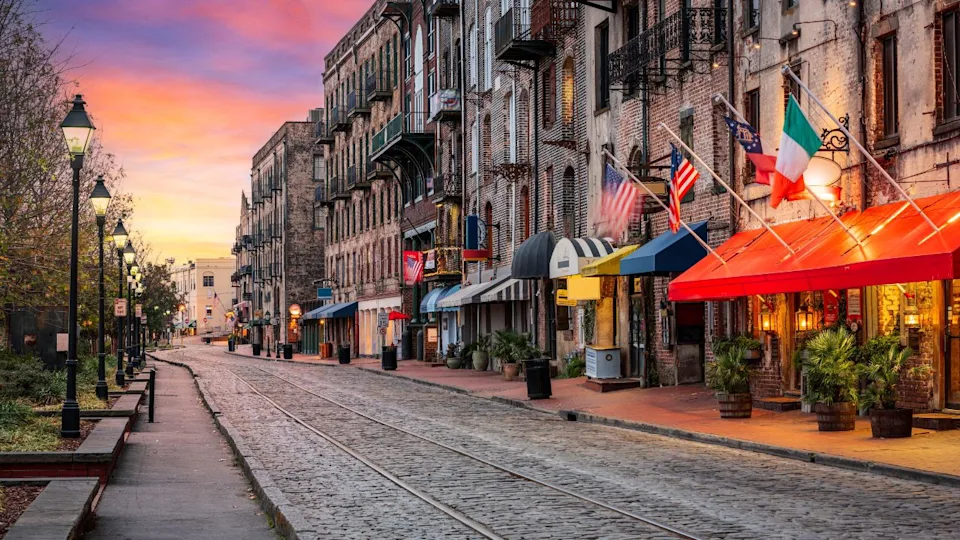 Savannah, Georgia, USA bars and restaurants on River Street at dawn.