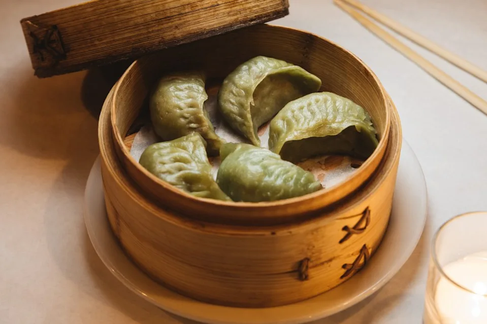 Green dumplings in a bamboo steamer. Courtesy of Brooklyn Chop House