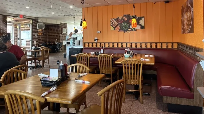 Seating area inside Odessa Diner with a corner booth and photos of food on the walls