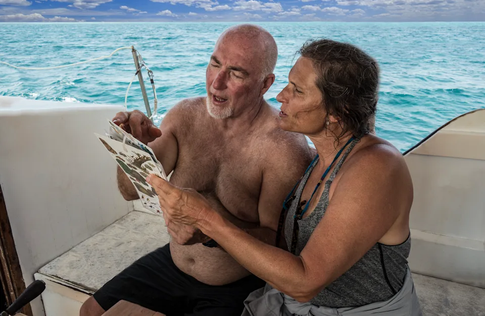 Retired American couple enjoying a boat outing in Belize while considering the country’s retirement visa program