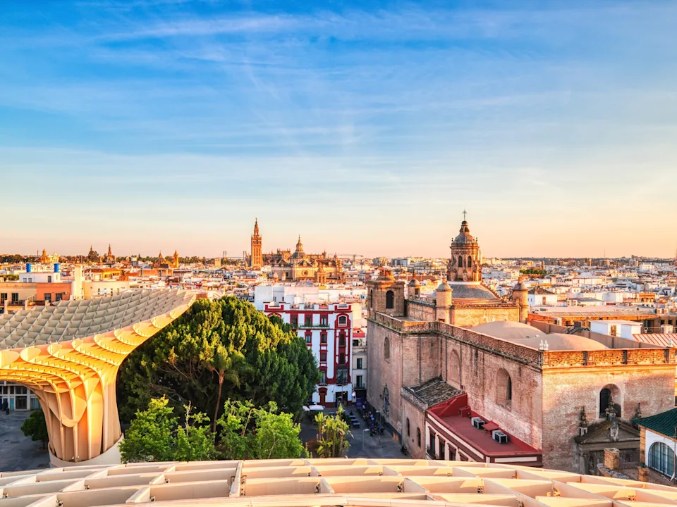 A wide shot of the city of Seville, Spain, at sunset.