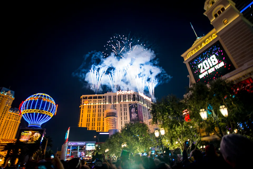Las Vegas, USA - January 01, 2018: New Year's Night Celebrations on Las Vegas Strip, Fireworks over Planet Hollywood Hotel and Casino. Crowds of people watching the show.