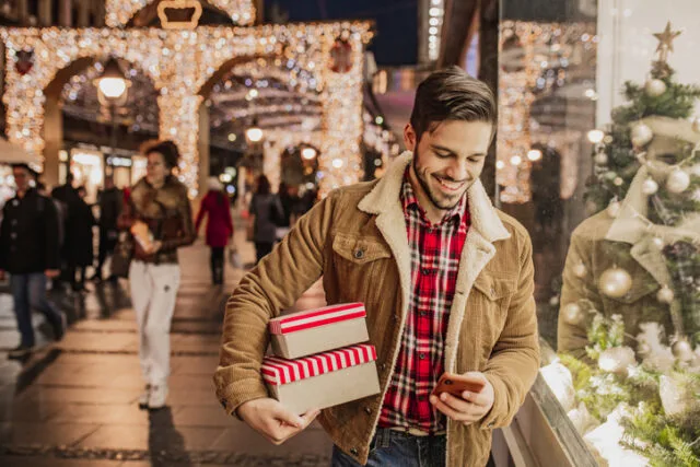 man walking with christmas presents