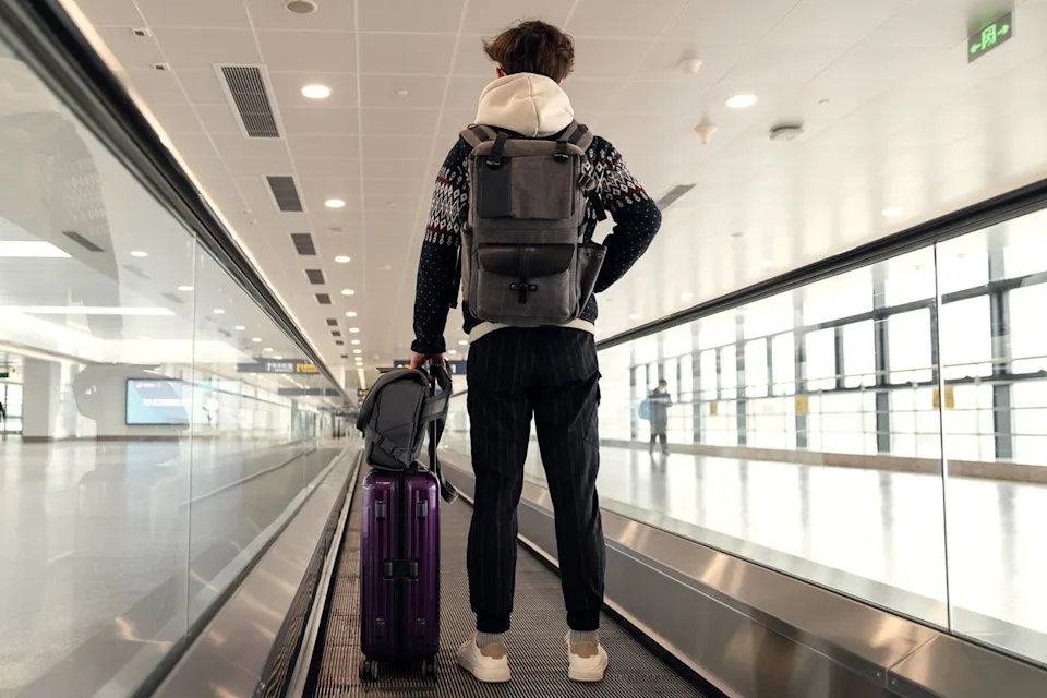 Getty A male solo traveler in an airport