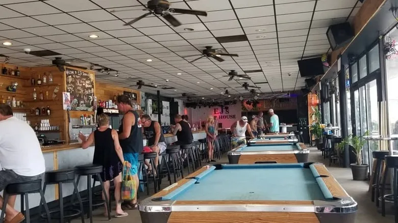 Interior of EJ's tap house with long bartop and pool tables