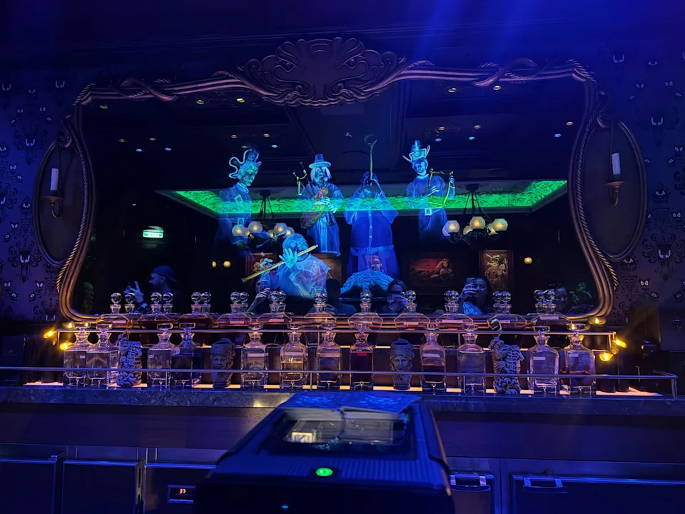 a mirror behind a bar with images of ghosts appearing in it
