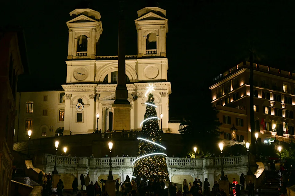 A picture shows a christmas tree on the Spanish Steps at night with Trinita dei Monti church in the background, in Rome on Dec. 2, 2025.