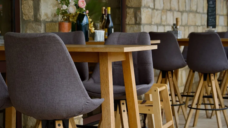 Dining at comfortable dining table. Empty restaurant in old town. Idyllic furniture in Europe. Elegant cozy pizzeria. Modern ambiance. Posh expensive coffee show. Menu. Patio. Lunch. Dinner. Bistro.