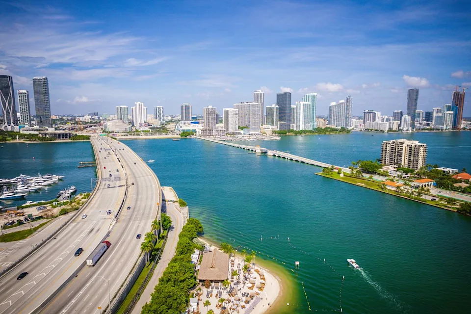 Jin / Adobe Stock Aerial view of a highway leading toward Biscayne Bay.