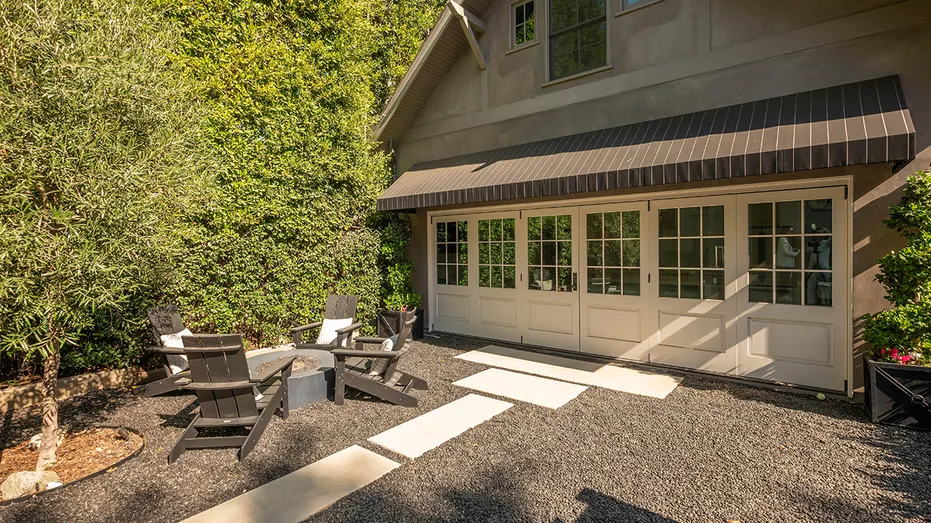 The backyard also features a fire pit.