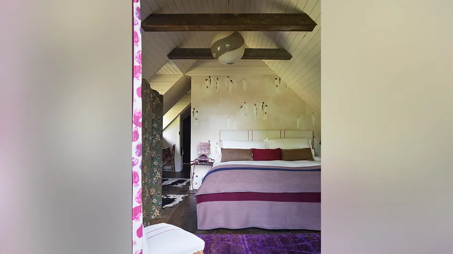 The bedroom features beamed ceilings.