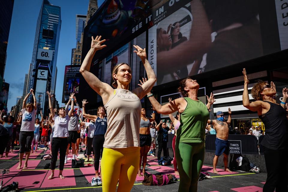 People taking part in a yoga session in New York City in June 2025. Yoga can help improve mobility, with benefits as we age (AFP via Getty Images)