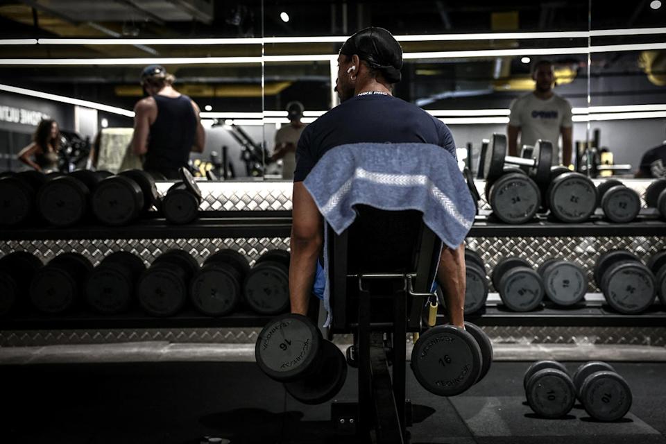 A man lifts weights during a workout (AFP via Getty)