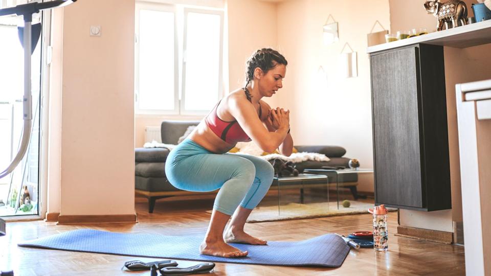  A photo of a woman performing a squat . 