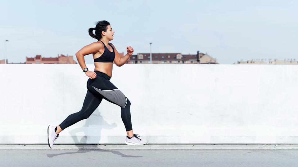 Woman sprinting outside in an urban area