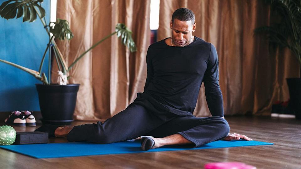  A man doing the 90/90 stretch. 