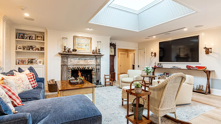 The family room features a wood-burning fireplace, a TV and bookshelves.