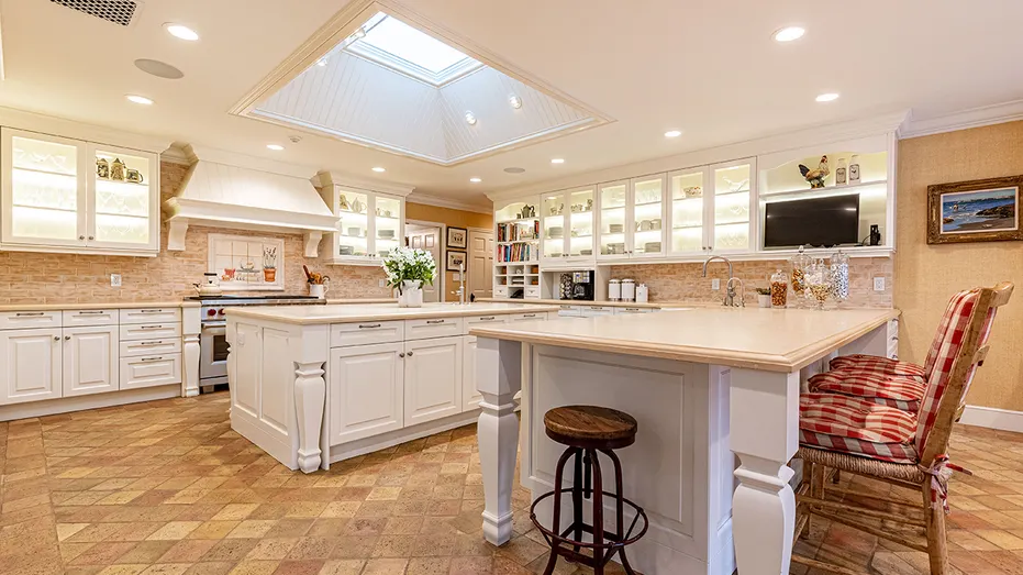The kitchen features a large center island and an eat-in bar.