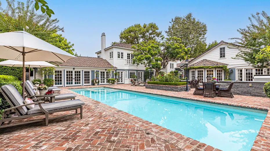 The backyard also features a swimming pool.