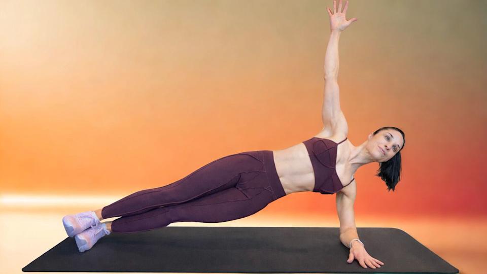 Woman performing side plank exercise. 