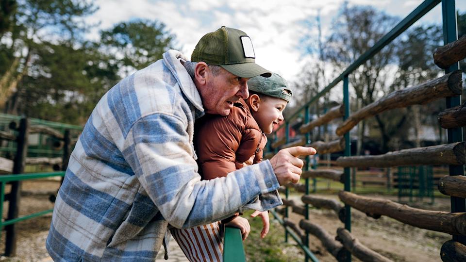Grandfather took his grandson to the zoo