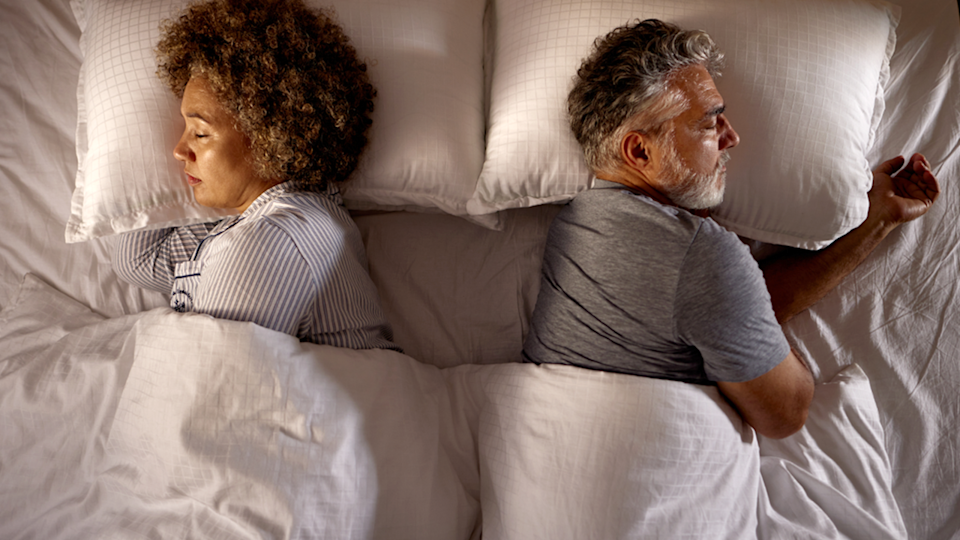woman and man sleeping in bed