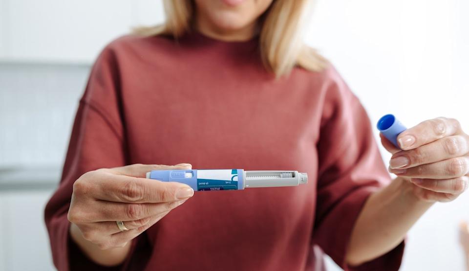 Woman holding hormone injection -peptides