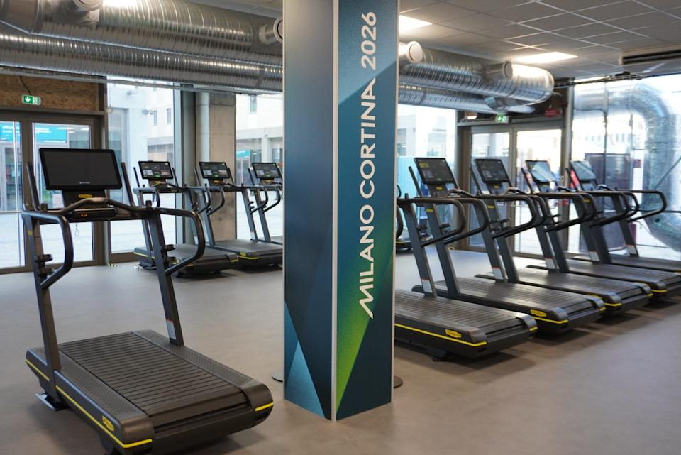 fitness area featuring treadmills and a promotional column for milano cortina 2026