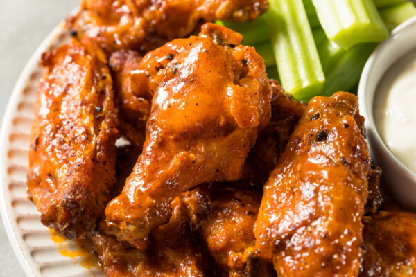 wings on a plate with a little celery in view